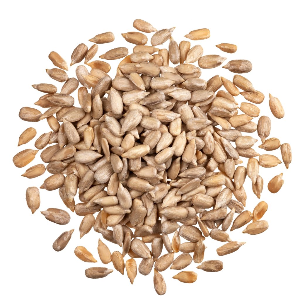 Peeled sunflower seeds isolated on white background with clipping path, top view